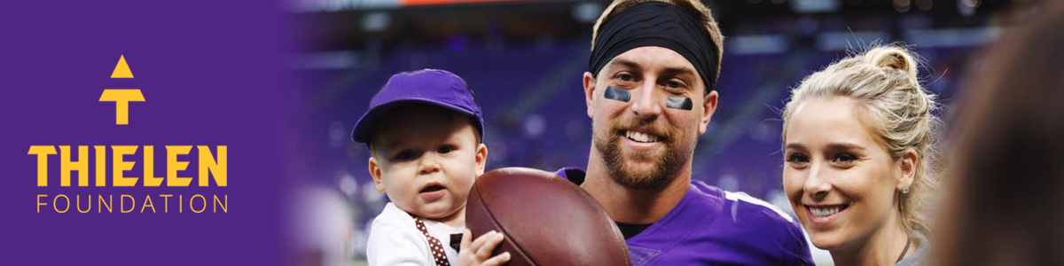 Adam Thielen with his wife and son.